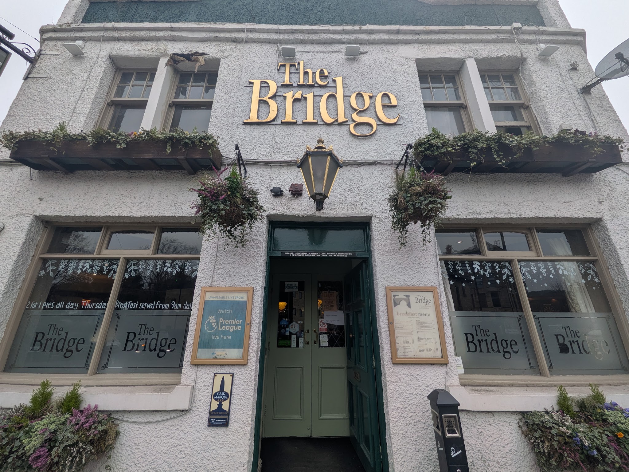 The Bridge's cream frontage, gold lettering and green entrance on Low Lane