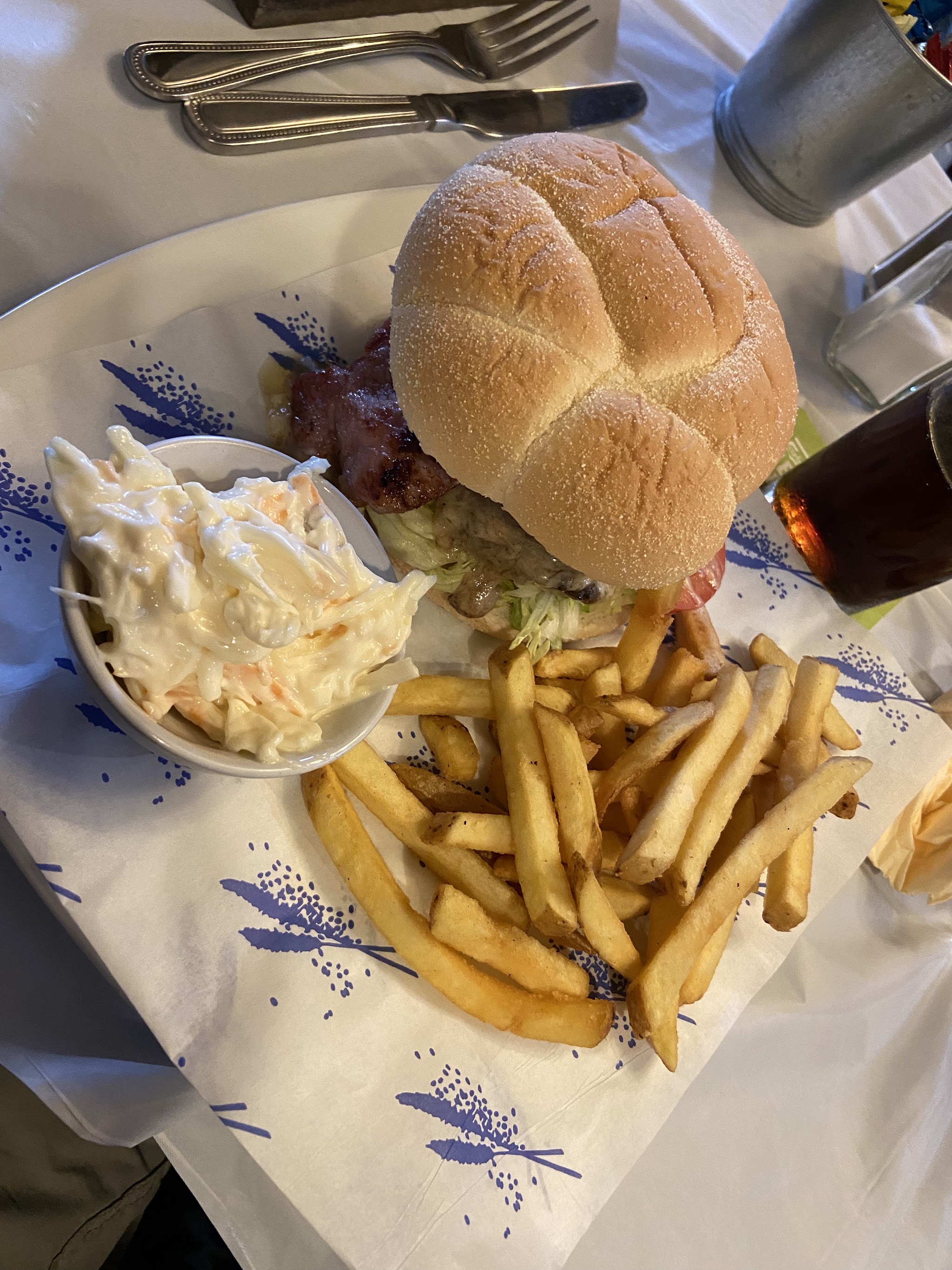 A burger with chips and coleslaw served at The Bridge